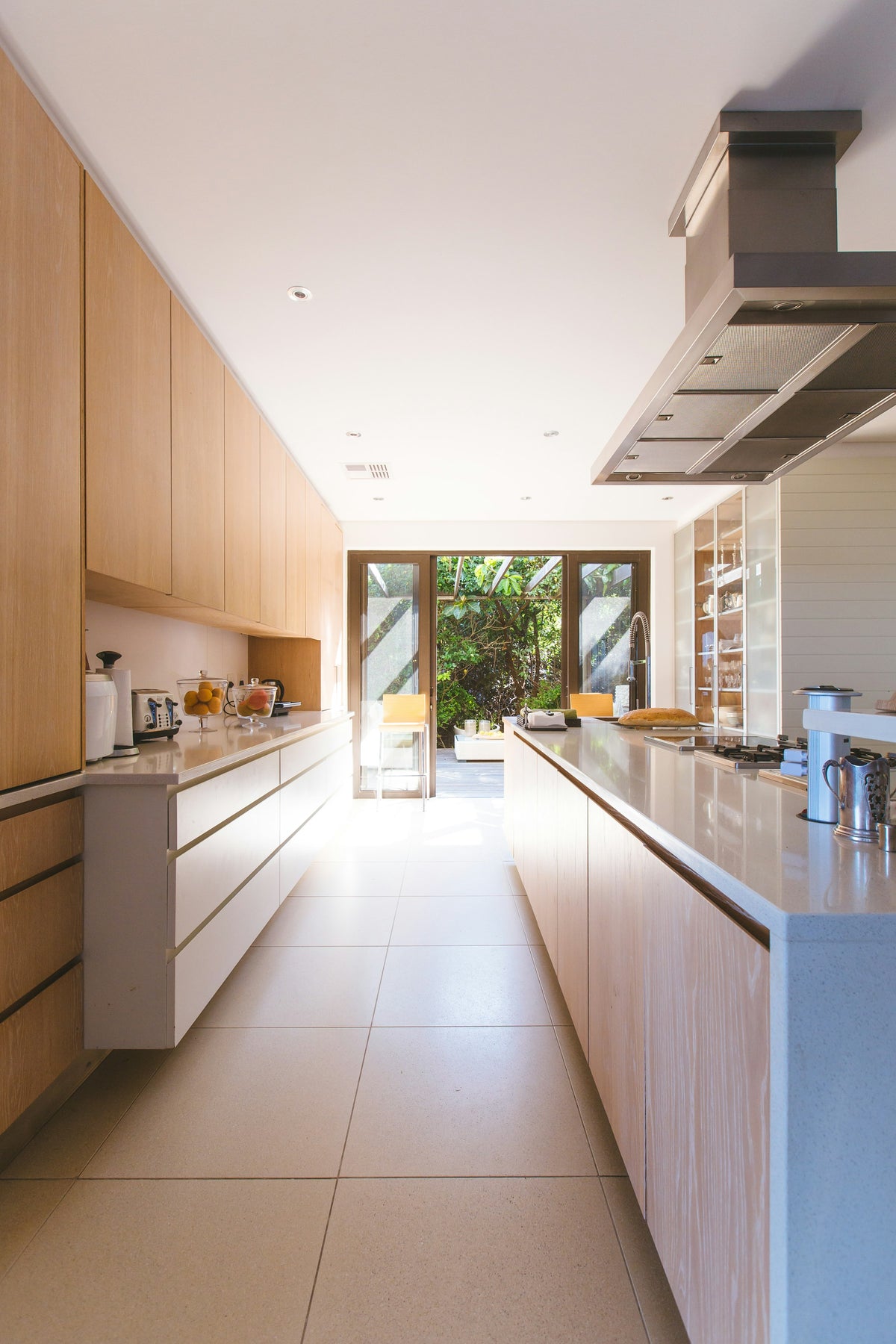 White kitchen island with cupboards and glass doors